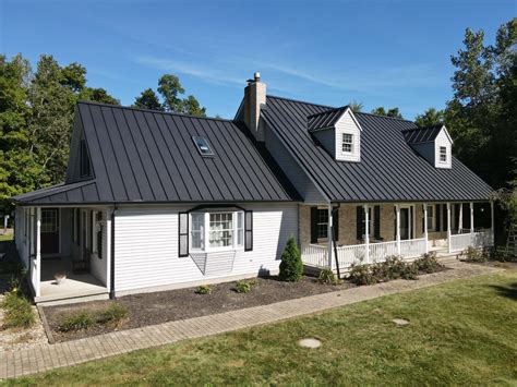 black metal roof brick house|houses with white metal roofs.